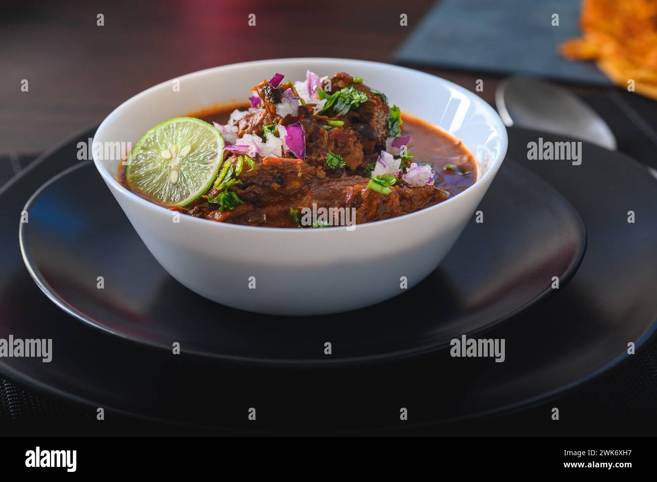 Bowl of Mexican Beef Birria Stew on Black Plates Stock Photo