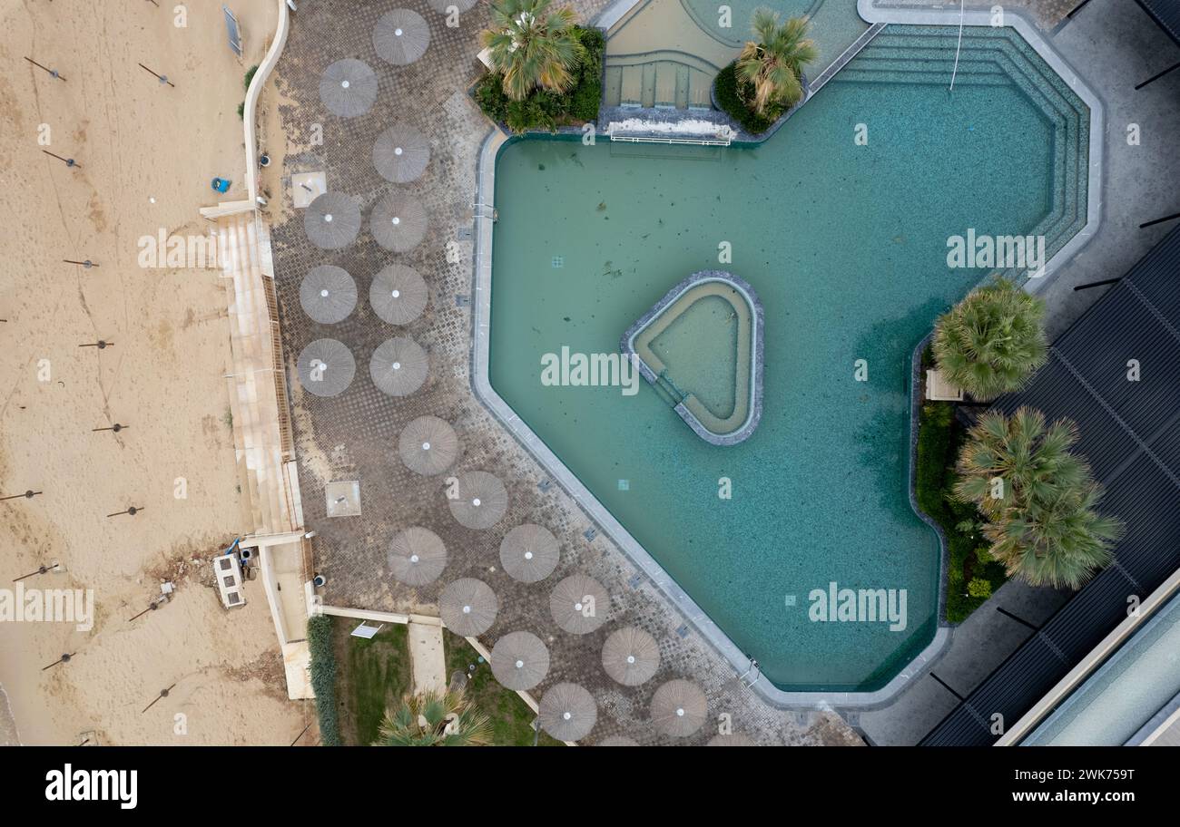 Drone aerial of empty abandoned deserted swimming pool. Dirty water ...