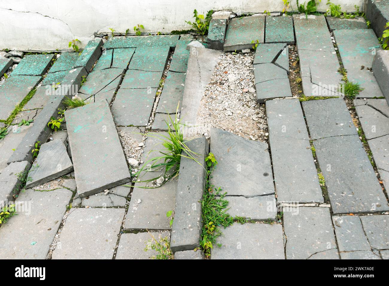 fragment of damaged city pavement with broken tile blocks Stock Photo