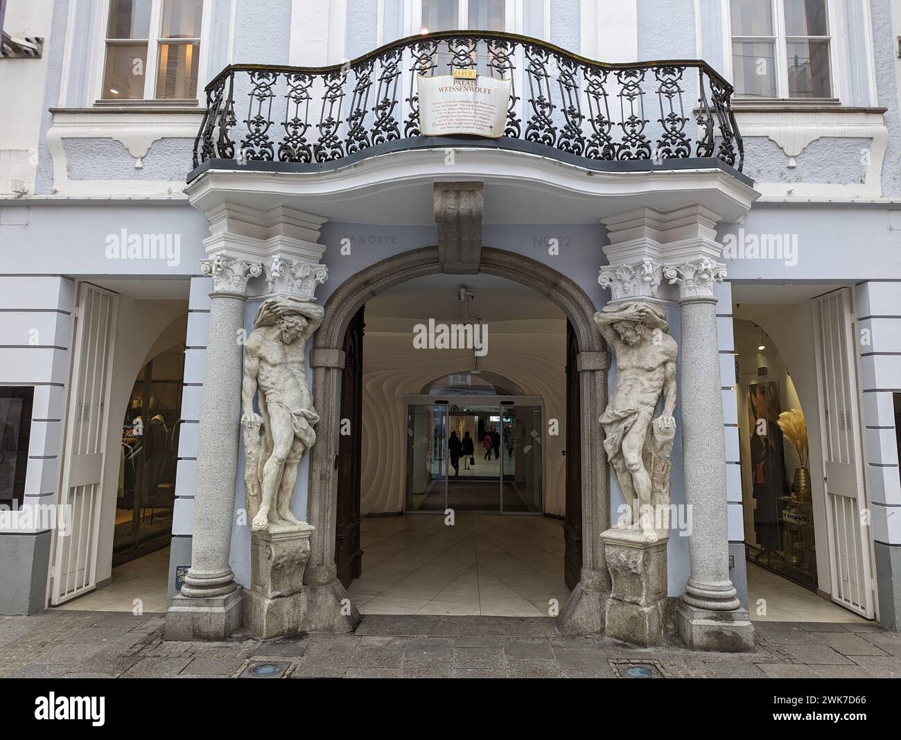 A Vintage building with two statues outside: Linz, Austria Stock Photo ...