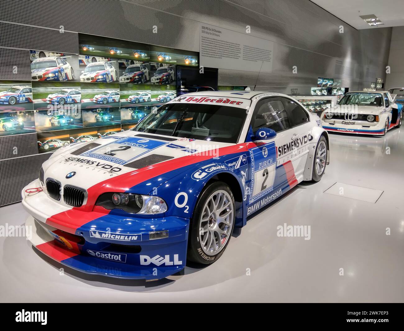 BMW racing car on display in a sleek showroom Stock Photo