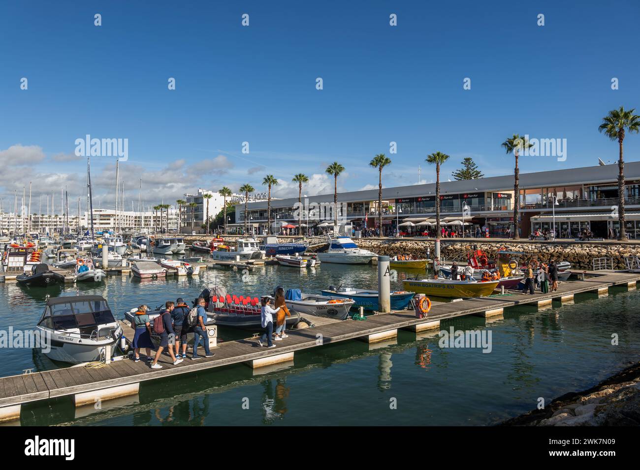 Lagos, Algarve, Portugal - October 21, 2023: Marina de Lagos with people on jetty back from a boat tour Stock Photo