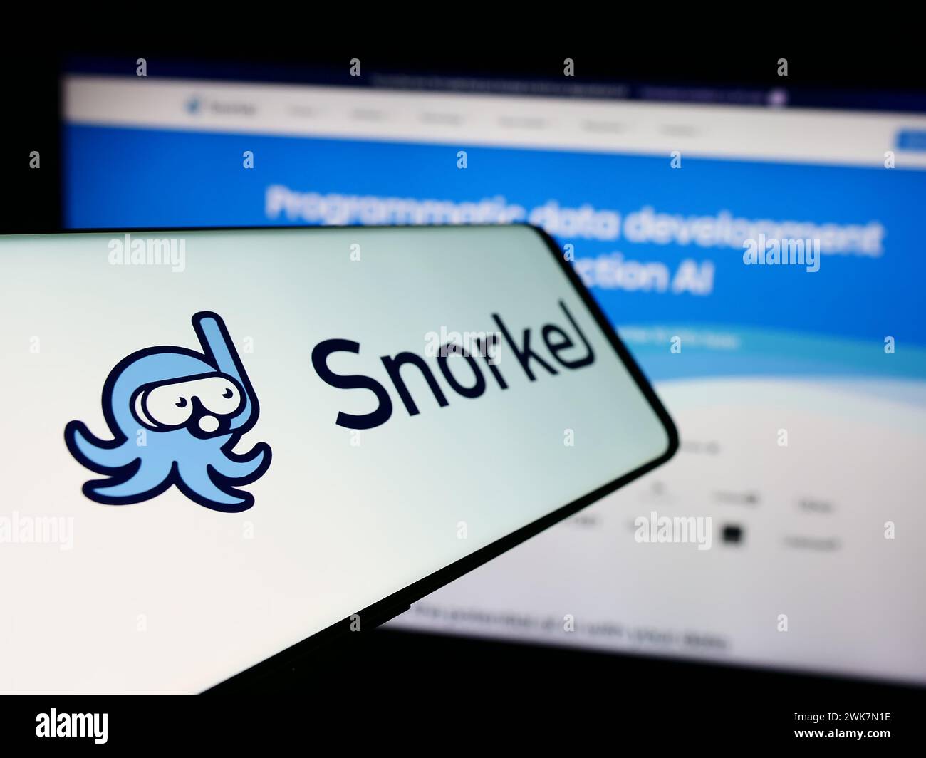 Cellphone with logo of American artificial intelligence company Snorkel AI Inc. in front of business website. Focus on left of phone display. Stock Photo