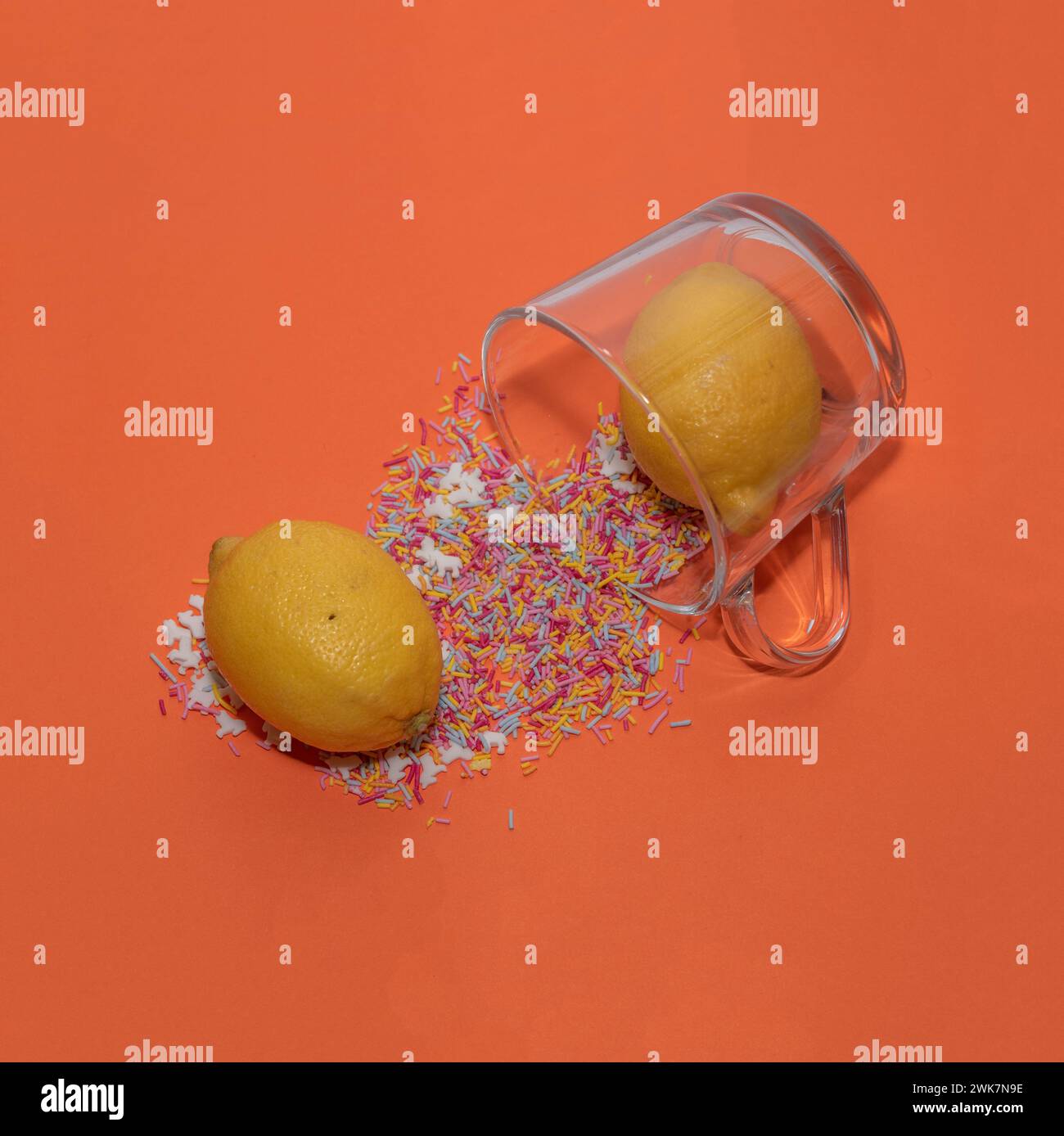 Lemons come out of the glass with sprinkles. Creative concept studio shot. Stock Photo