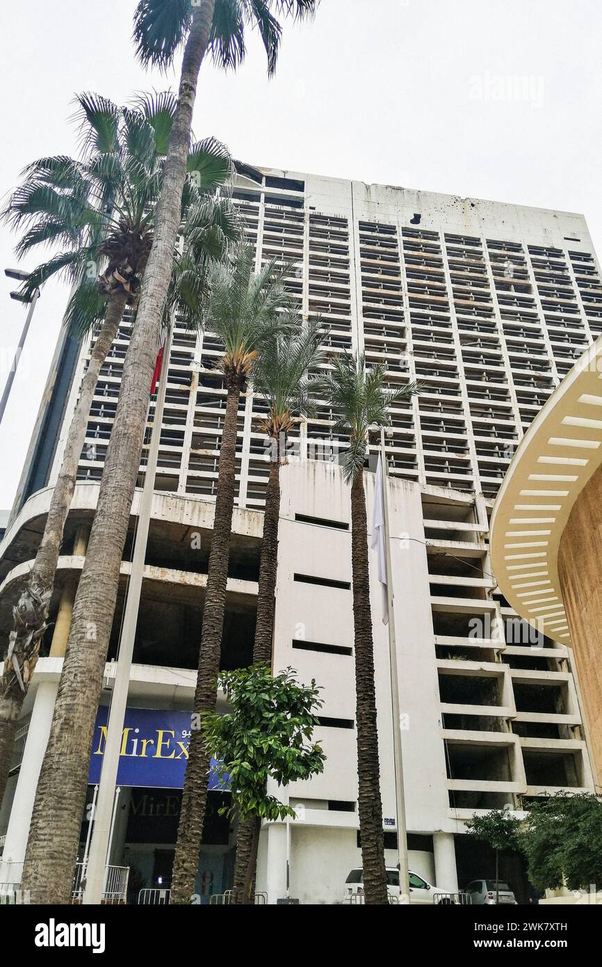 Lebanon, Beirut, Bullet-riddled pockmarked exterior of the green line 400-room Holiday Inn in Beirut, Lebanon, an important landmark left from the Lebanese Civil War Stock Photo