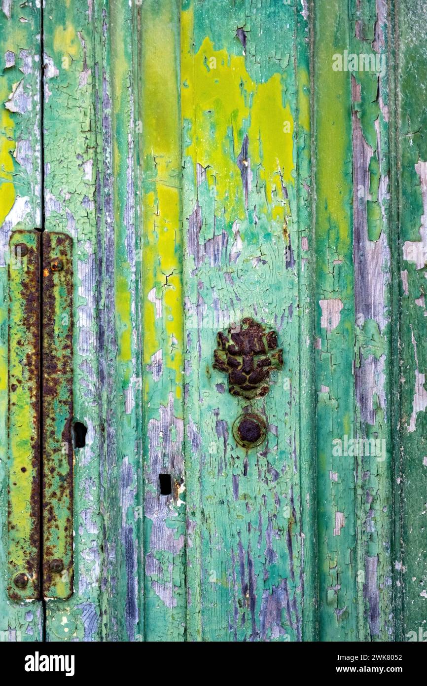 Flaking paint on an old wooden door in Malta Stock Photo