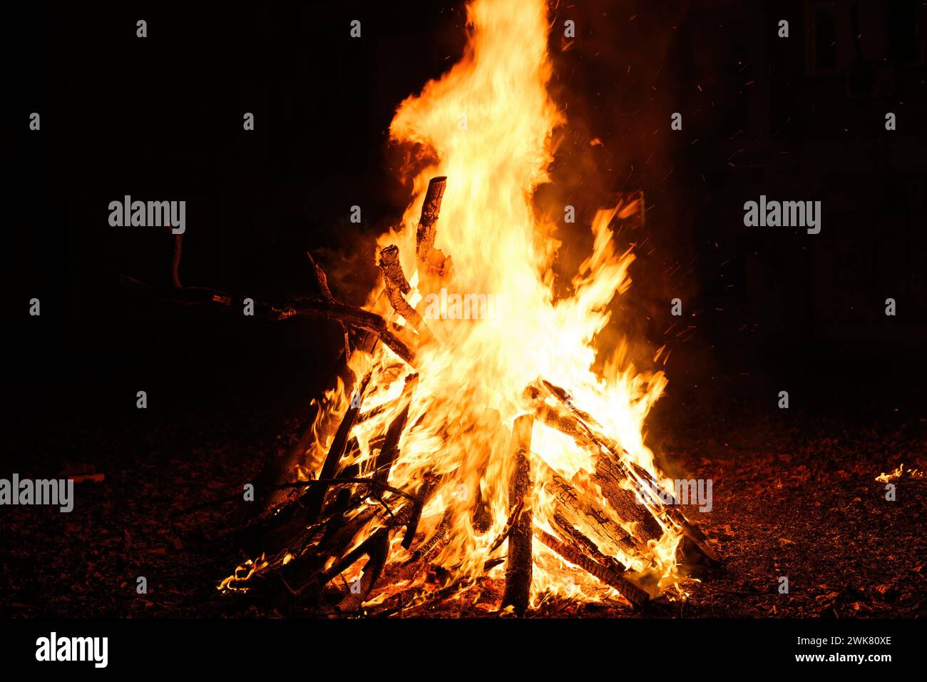 Bonfire burning at night, bright orange flames of fire, selective focus Stock Photo