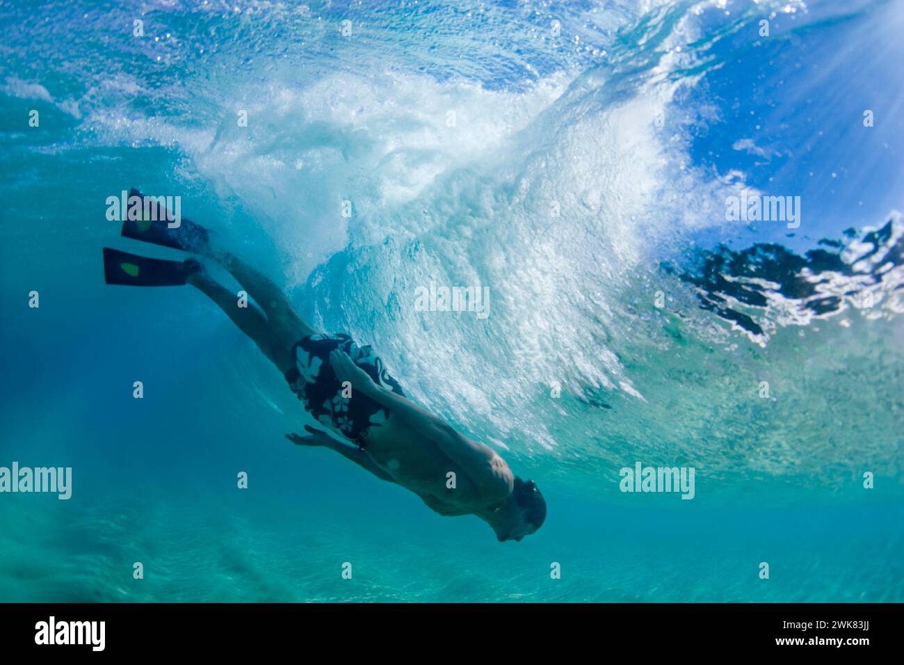 underwater picture of man bodysurfing in Hawaii Stock Photo