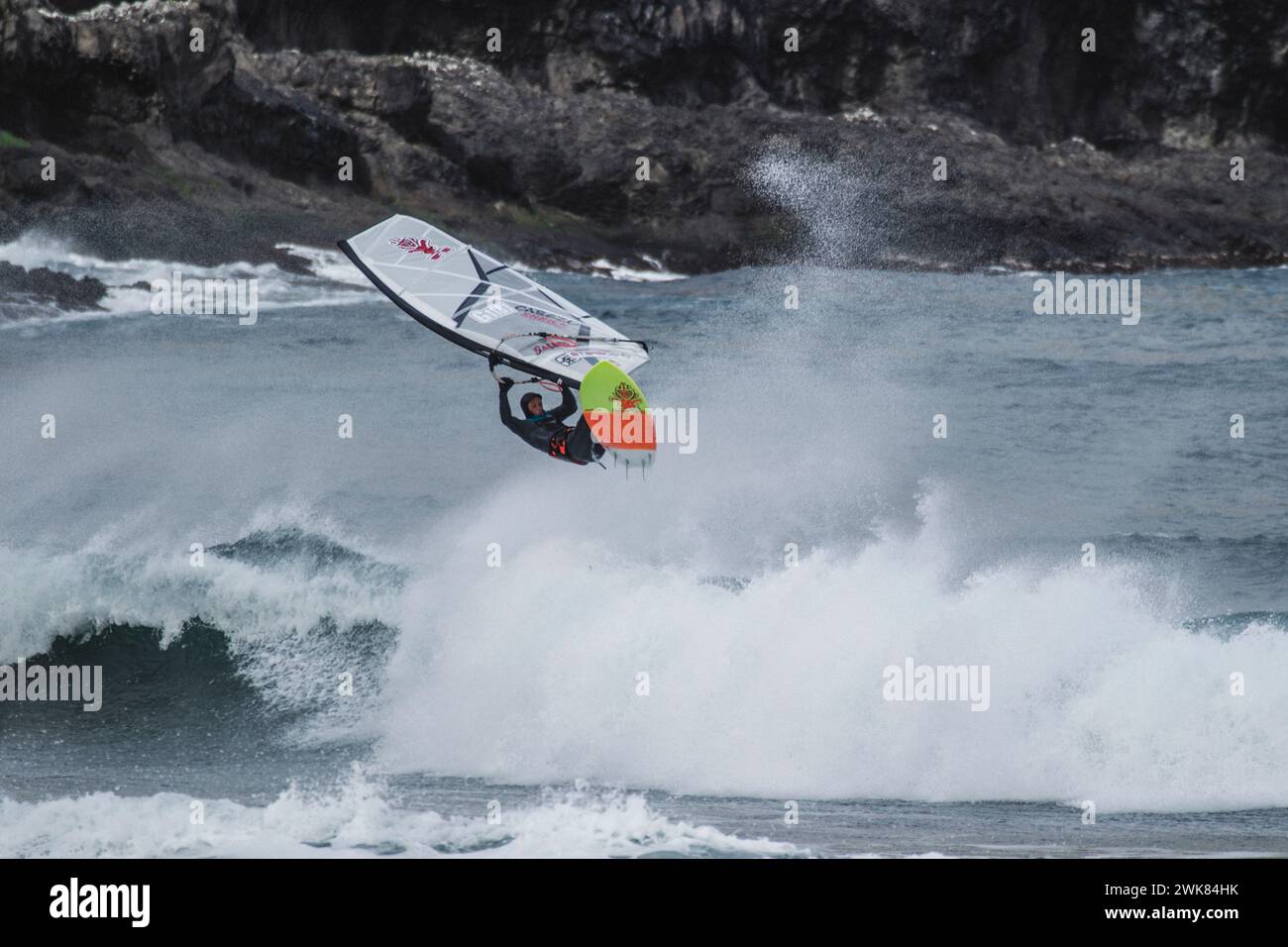 Professional Windsurfer In The Freezing Water Of The Faroe Islands Stock Photo
