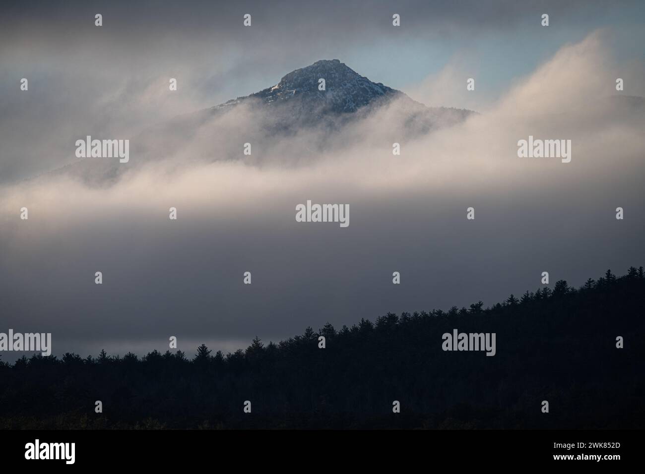Ice Covered Mount Chocorua Through The Clouds Stock Photo