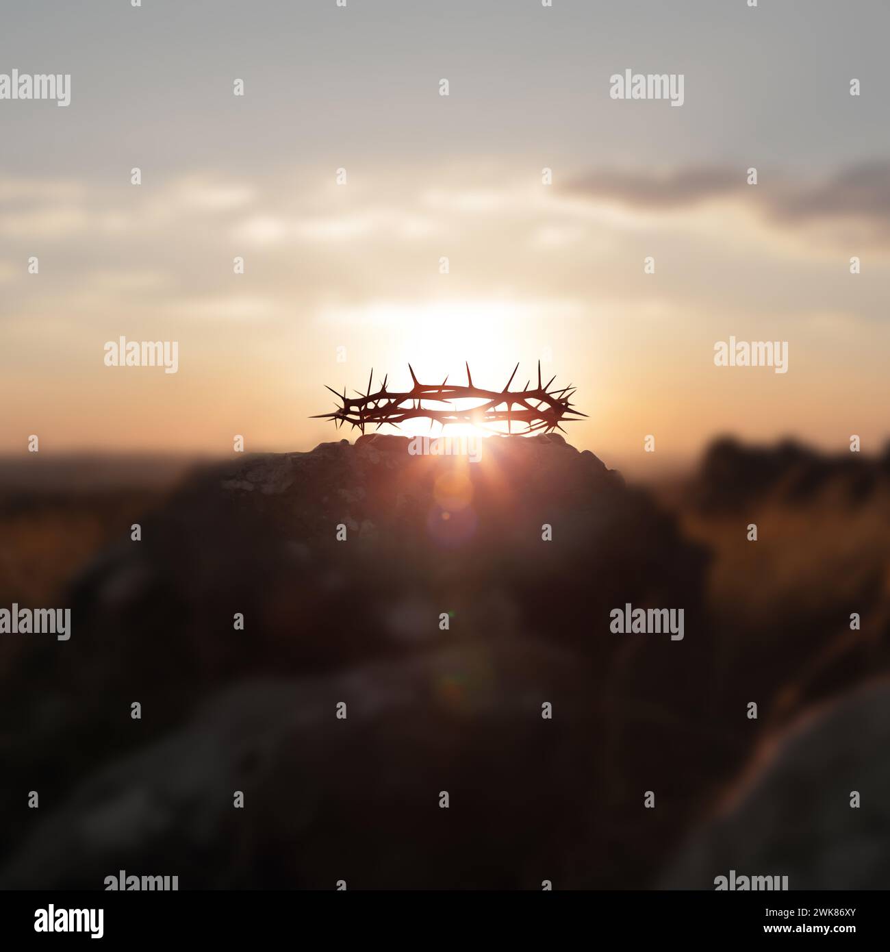 Crown of thorns on Calvary Hill, symbolizing the cross suffering of Jesus Christ, and red sunset and Passion Week and Lent Easter background Stock Photo