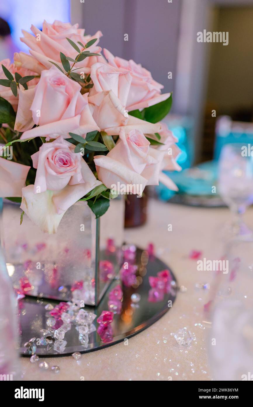 Pink roses in a square mirror vase as table centerpiece Stock Photo Alamy