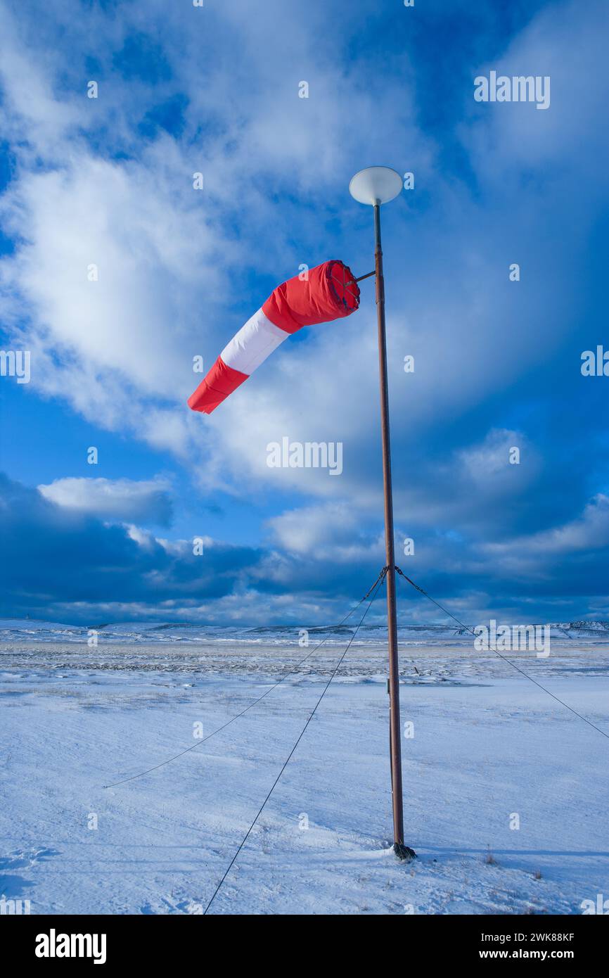 Windsock against beautiful blue sky with nice clouds Stock Photo
