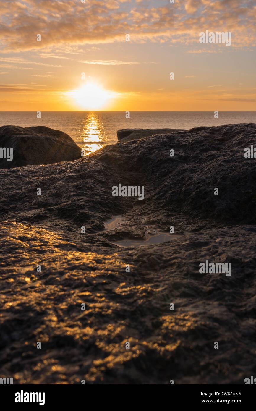 Sunrise over the North Sea and the coastal defences on Felixstowe beach Suffolk England UK. February 2024 Stock Photo
