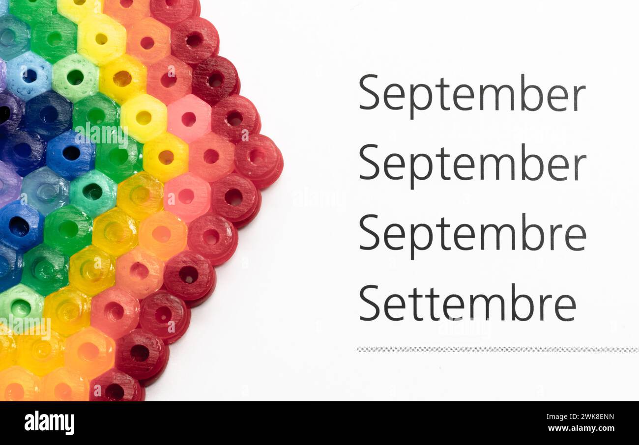 The calendar month of September in german, english, french and italian - a rainbow decoration Stock Photo