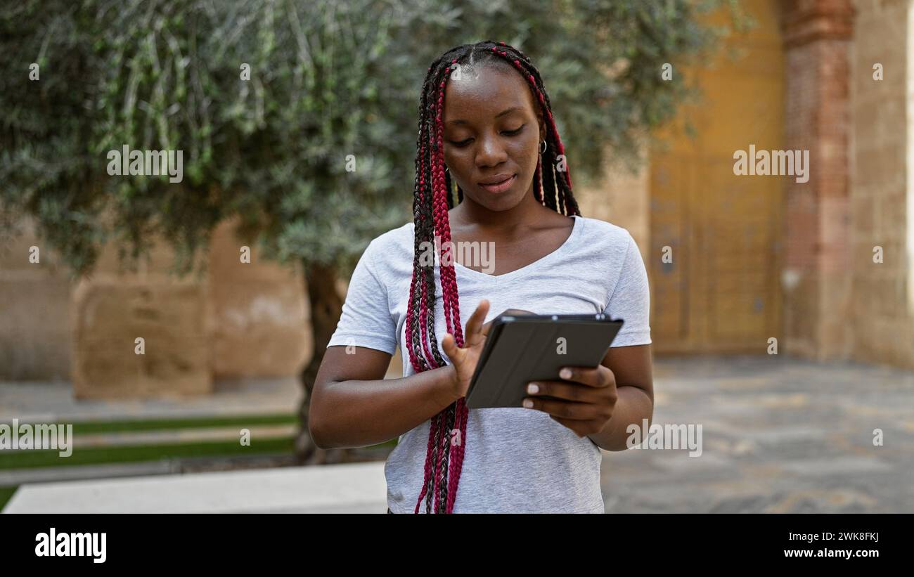 Focused african woman braids using hi-res stock photography and images ...