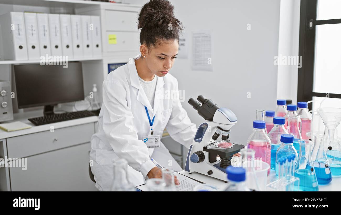 In the heart of a lab, a young, beautiful hispanic woman scientist ...