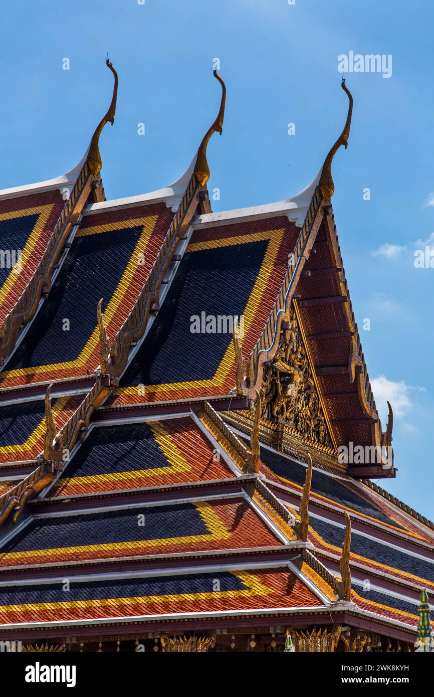Roof detail of the Temple of the Emerald Buddha at the Grand Palace complex in Bangkok, Thailand.  The elaborate chofa, bai raka and hong hongse are s Stock Photo