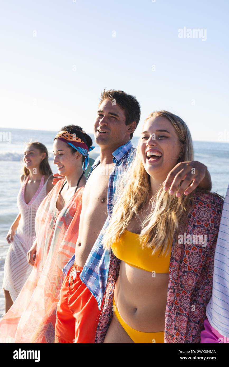 Diverse group of friends enjoy a sunny beach day Stock Photo