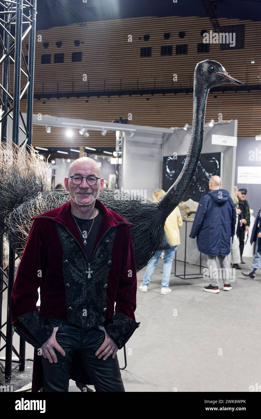 Paris, France. 17th Feb, 2024. Artist Emmanuel Guillon poses next to