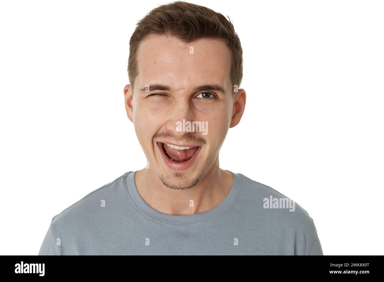 portrait of young happy man winking looking at the camera on white ...