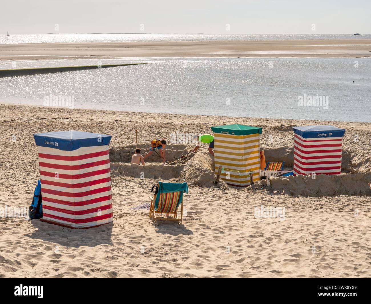 Boys playing with sand on beach of East Frisian island Borkum, Lower Saxony, Germany Stock Photo