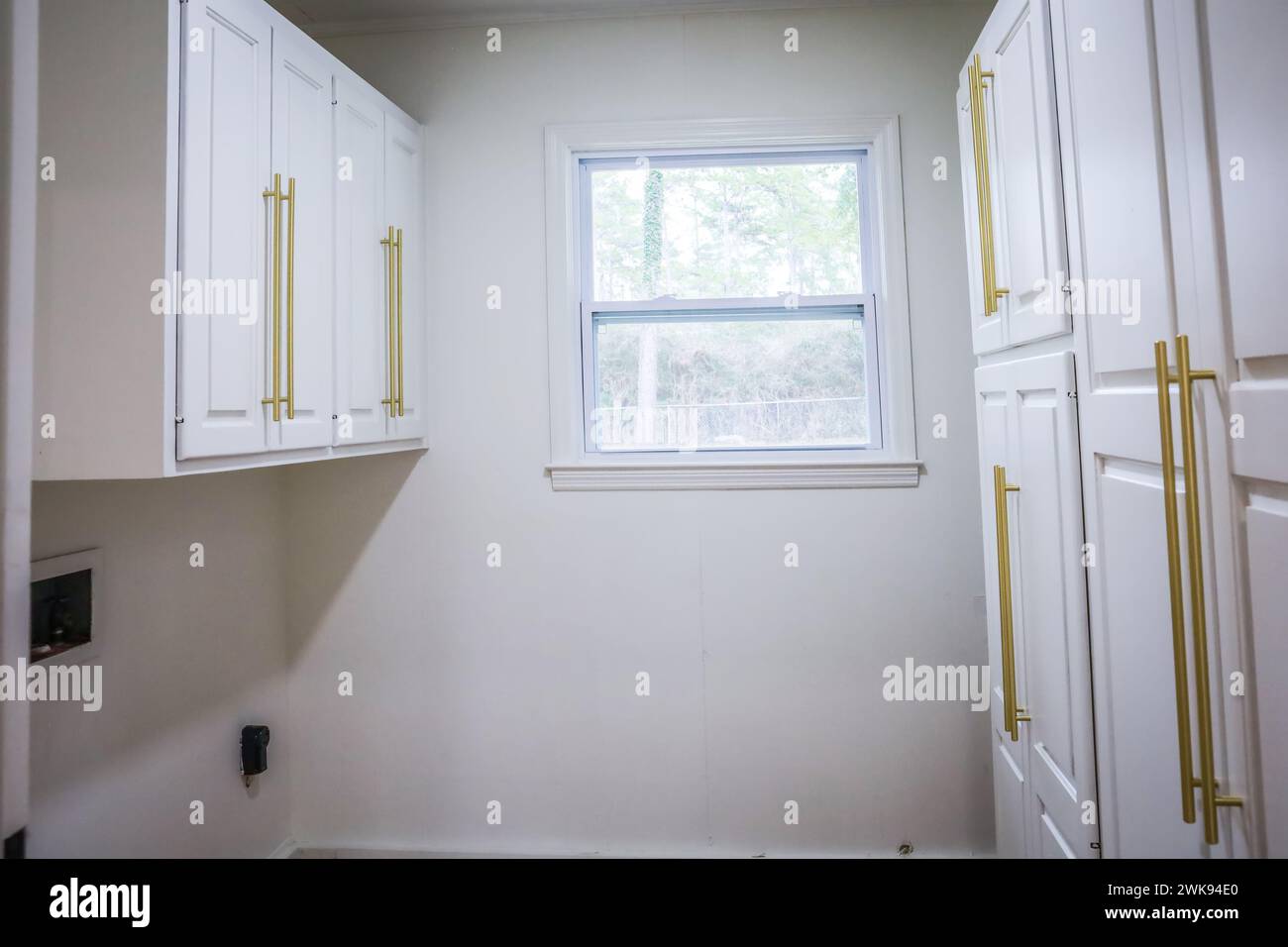 Updated white shaker cabinets with elegant gold sleek thin hardware in ...