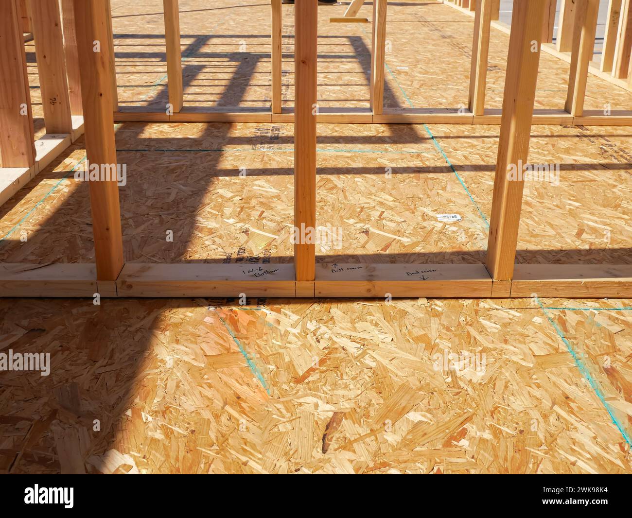 OSB sub flooring sheets cover, attach to the joists with wood screws