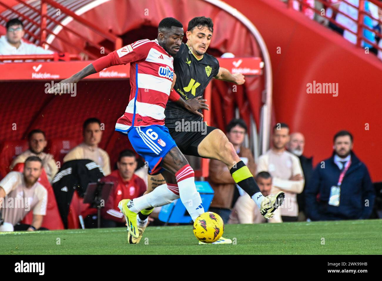 February 18, 2024, Granada, Granada, Spain: Martin Hongla of Granada CF competes for the ball with Lucas Robertone of UD AlmerÃa during the Liga match between Granada CF - UD AlmerÃa at Nuevo Los CÃrmenes Stadium on February 18, 2024 in Granada, Spain. (Credit Image: © JosÃ© M Baldomero/Pacific Press via ZUMA Press Wire) EDITORIAL USAGE ONLY! Not for Commercial USAGE! Stock Photo