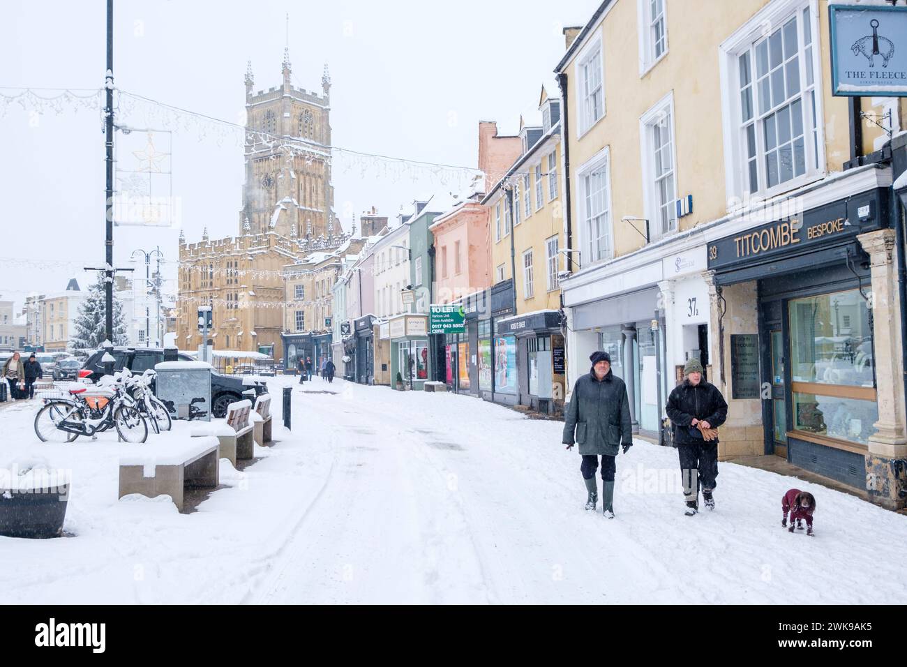 Heavy snow has fallen in the Cirencester in then Cotswolds. People are seen  out walking and playing in Cirencester park adn the Abbey grounds. Stock Photo