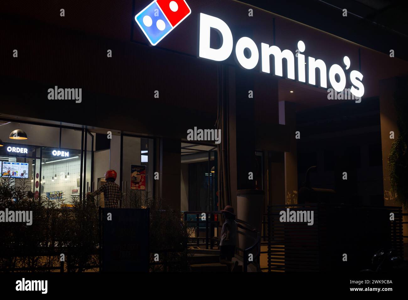 Jaipur, Rajasthan, India - November 6th 2023: A view of Domino's pizza shop from outside at night Stock Photo