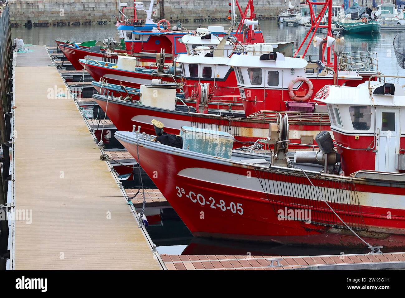 Colourful fleet of fishing boats moored in the sheltered waters of Port El Ferrol, La Coruna, Galicia, Spain, April 2023. Stock Photo