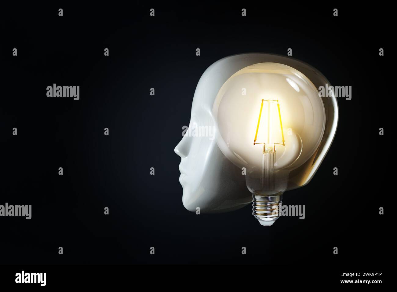 White head of a mannequin with a glowing light bulb in the brain, concept for thoughts, mind, ideas and creativity or for artificial intelligence, bla Stock Photo