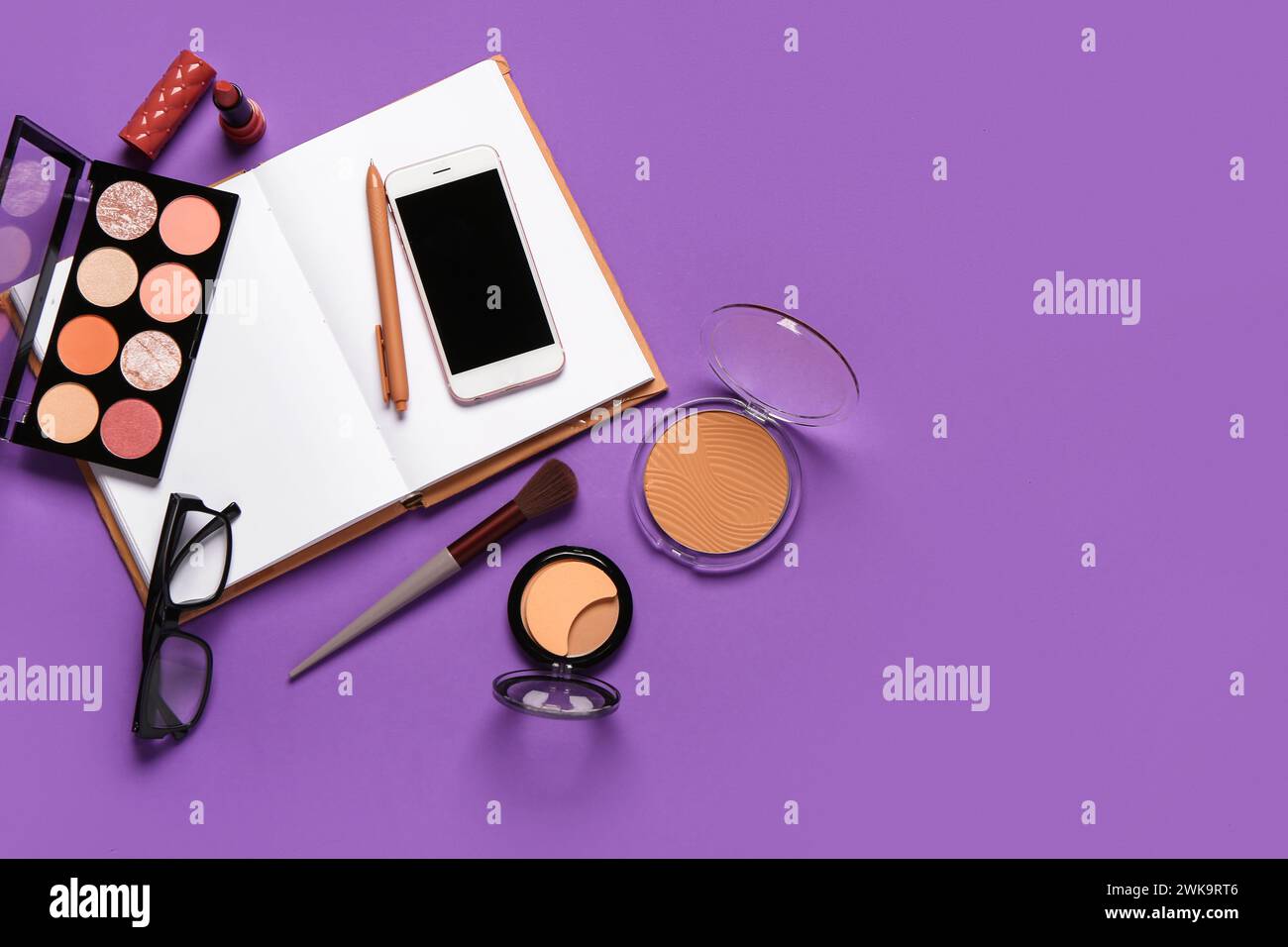 Composition with makeup cosmetics, modern mobile phone, eyeglasses and ...