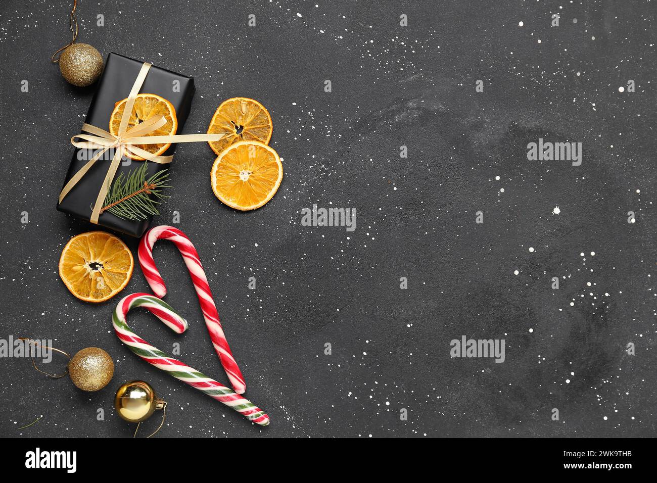 Gift box with dried orange slices, Christmas balls and candy canes on ...