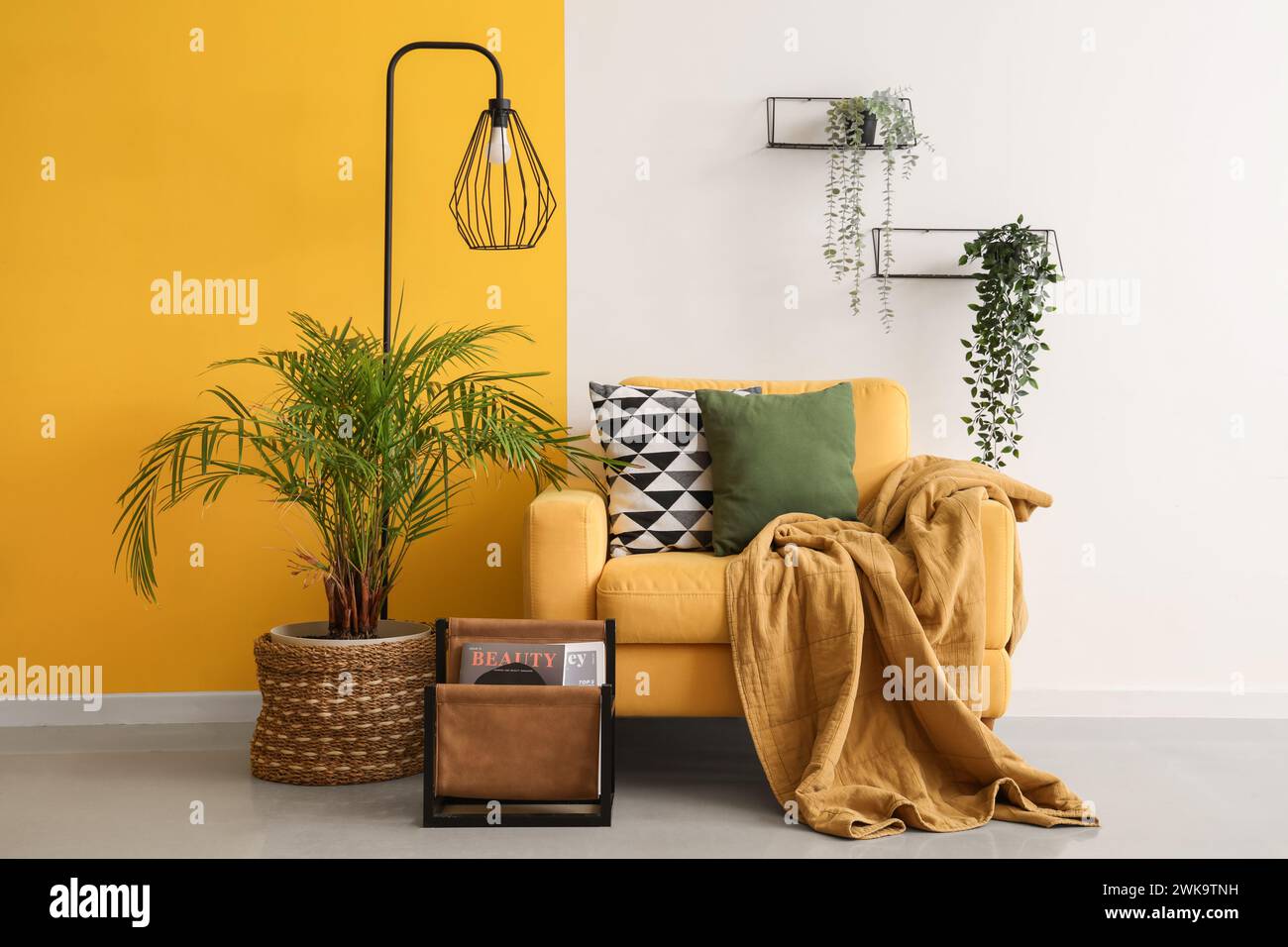 Interior of stylish living room with armchair, plants and lamp Stock ...