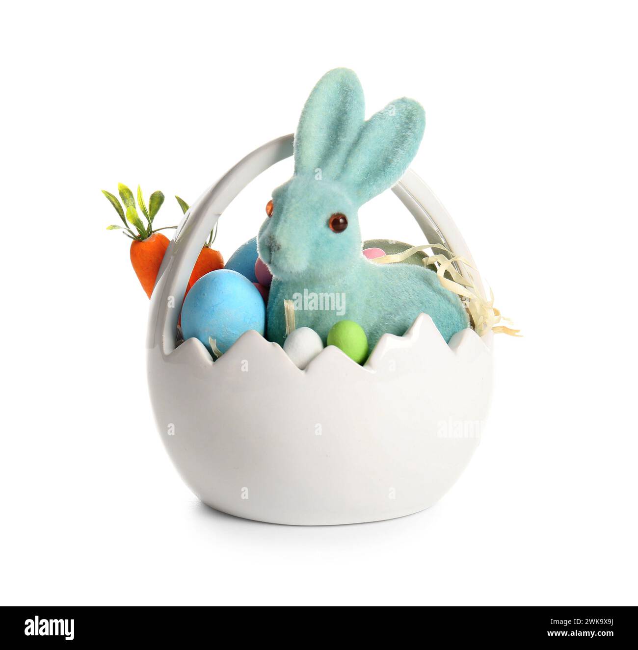 Ceramic basket with painted Easter eggs and toy bunny on white ...