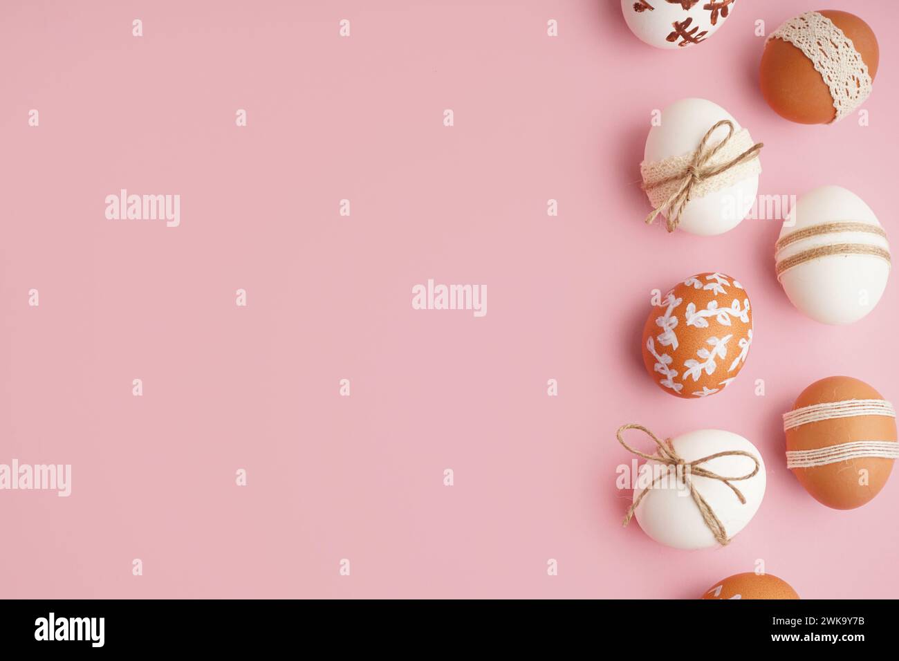 Composition with decorated Easter eggs on pink background Stock Photo
