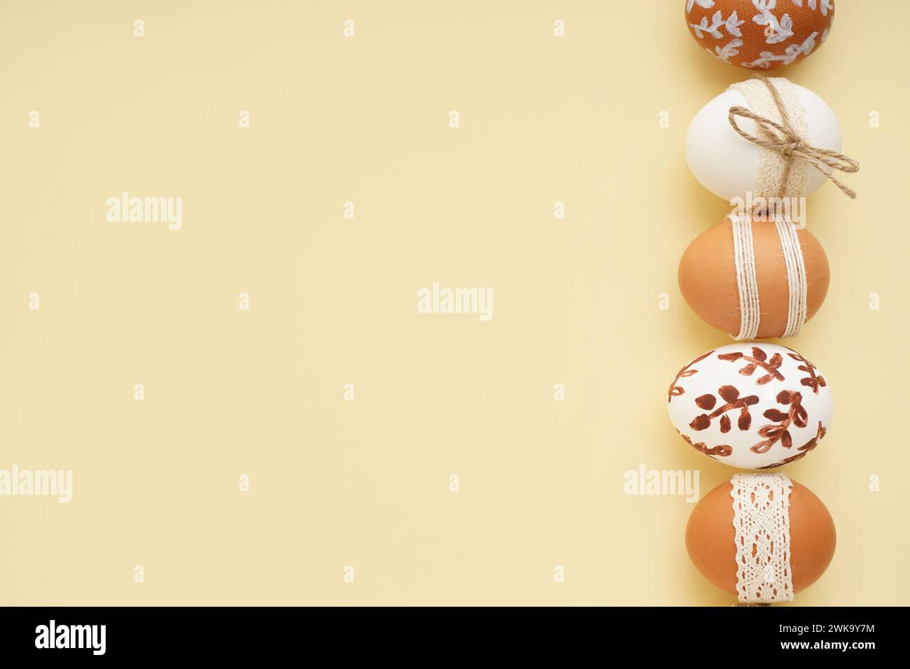 Composition with decorated Easter eggs on beige background Stock Photo