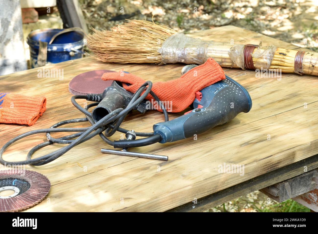 A drill, gloves and a grinding wheel, a carpenter's tool lie on a
