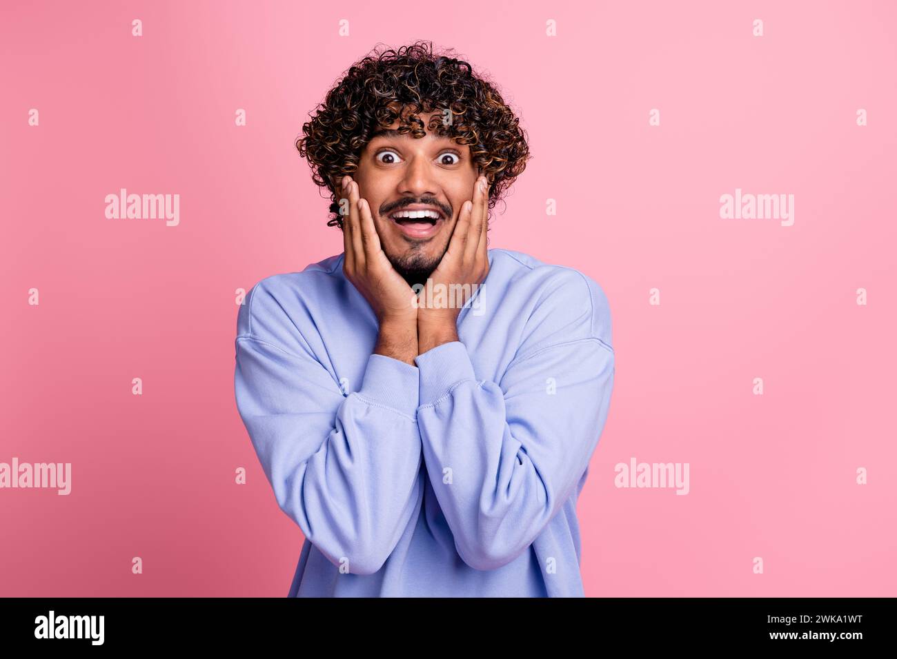 Photo of funky positive guy wear blue trendy clothes arms touch cheeks ...