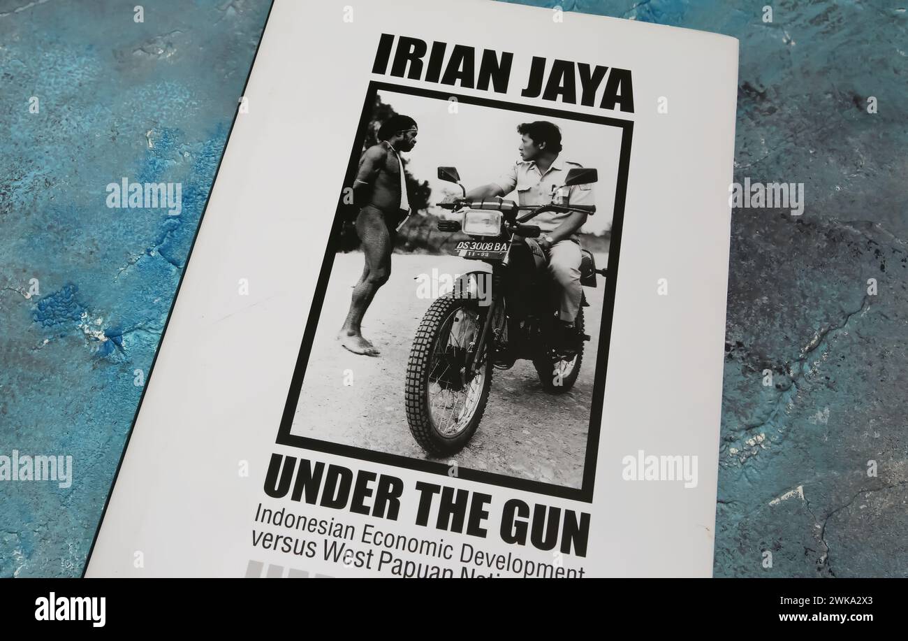 Viersen, Germany - January 9. 2024: Closeup of Jim Elmslie book cover Irian Jaya under the gun from 2003 Stock Photo
