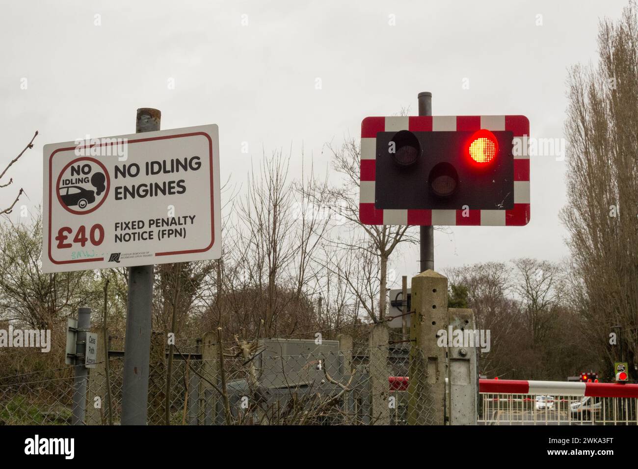 No idling engines fixed penalty notice signage at a level crossing in London, England, U.K. Stock Photo