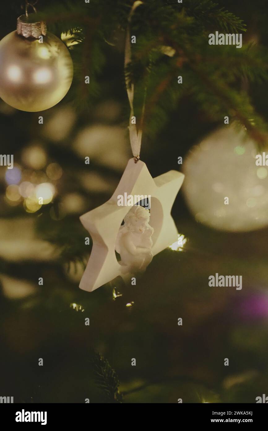 A star-shaped ornament with angel hanging from it Stock Photo