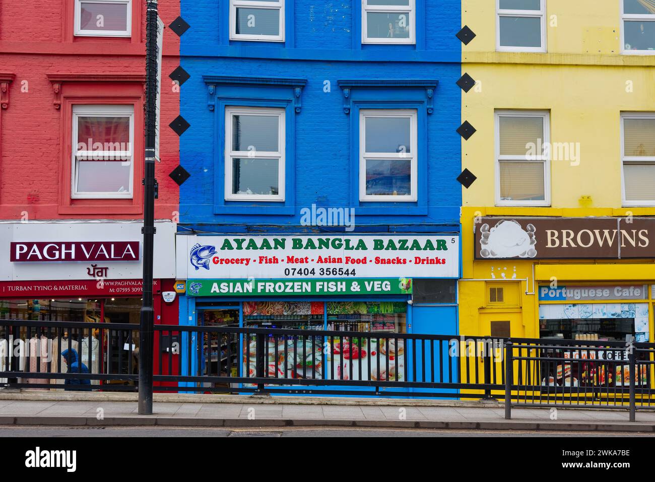 Brightly coloured retail shops on South Road in Southall West London England UK Stock Photo