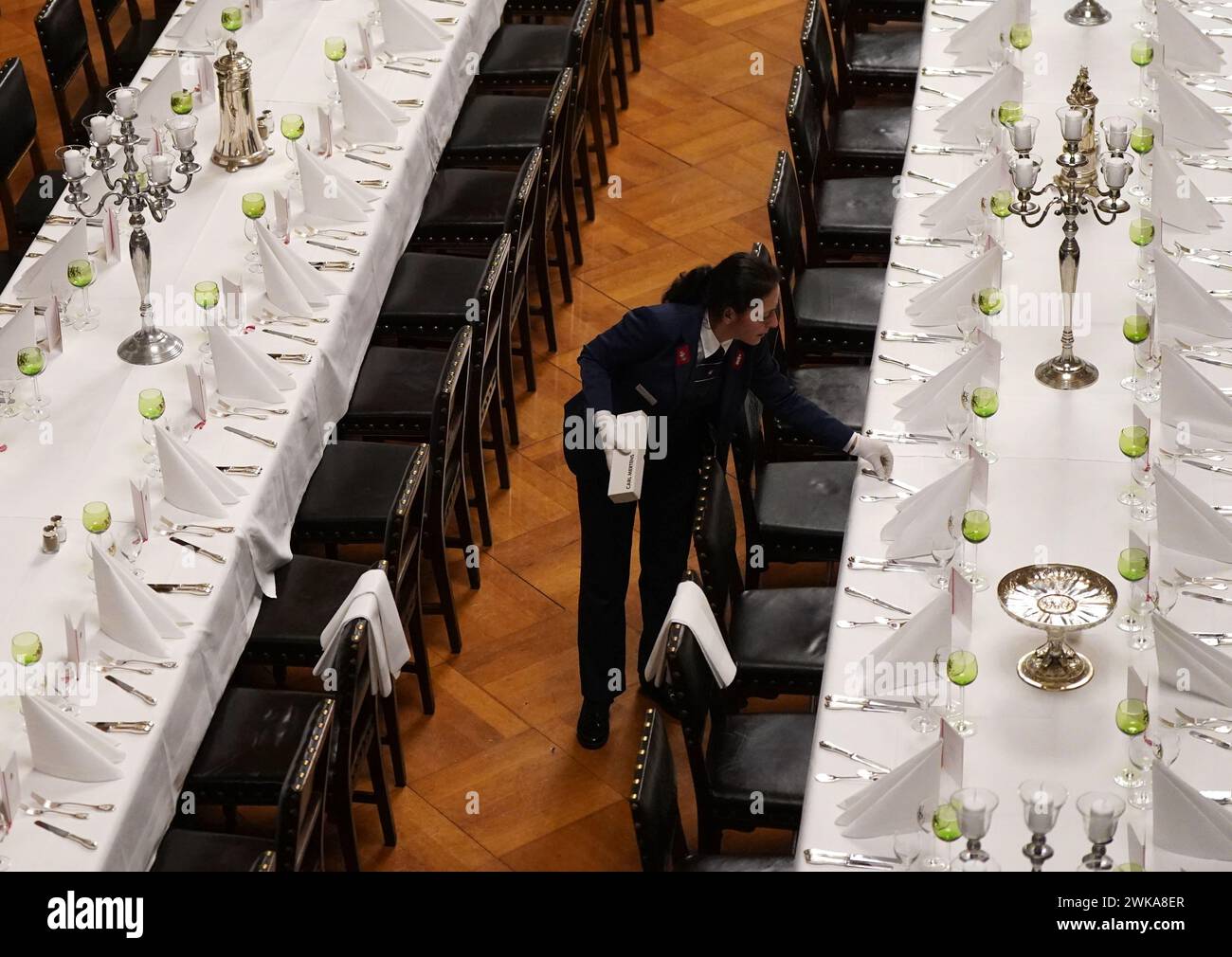 Hamburg, Germany. 19th Feb, 2024. Council servant Nadine Petermann checks the cutlery at the tables in the large banqueting hall during the final preparations for the traditional Matthiae meal of the Hamburg Senate in City Hall. The Prime Minister of the Republic of Estonia, Kallas, and Federal Chancellor Scholz are expected to attend the Matthiae meal as guests of honor. The Matthiae banquet is considered to be the oldest still celebrated banquet in the world. Credit: Marcus Brandt/dpa/Alamy Live News Stock Photo