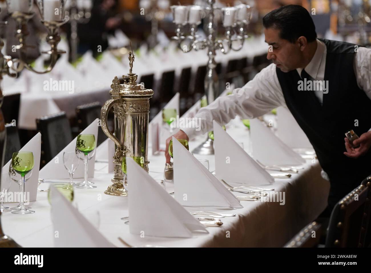 Hamburg, Germany. 19th Feb, 2024. A council servant places salt and pepper shakers on the tables during the final preparations for the Hamburg Senate's traditional Matthiae meal in the large banqueting hall at City Hall. The Prime Minister of the Republic of Estonia, Kallas, and Federal Chancellor Scholz are expected to attend the Matthiae meal as guests of honor. The Matthiae banquet is considered to be the oldest still celebrated banquet in the world. Credit: Marcus Brandt/dpa/Alamy Live News Stock Photo