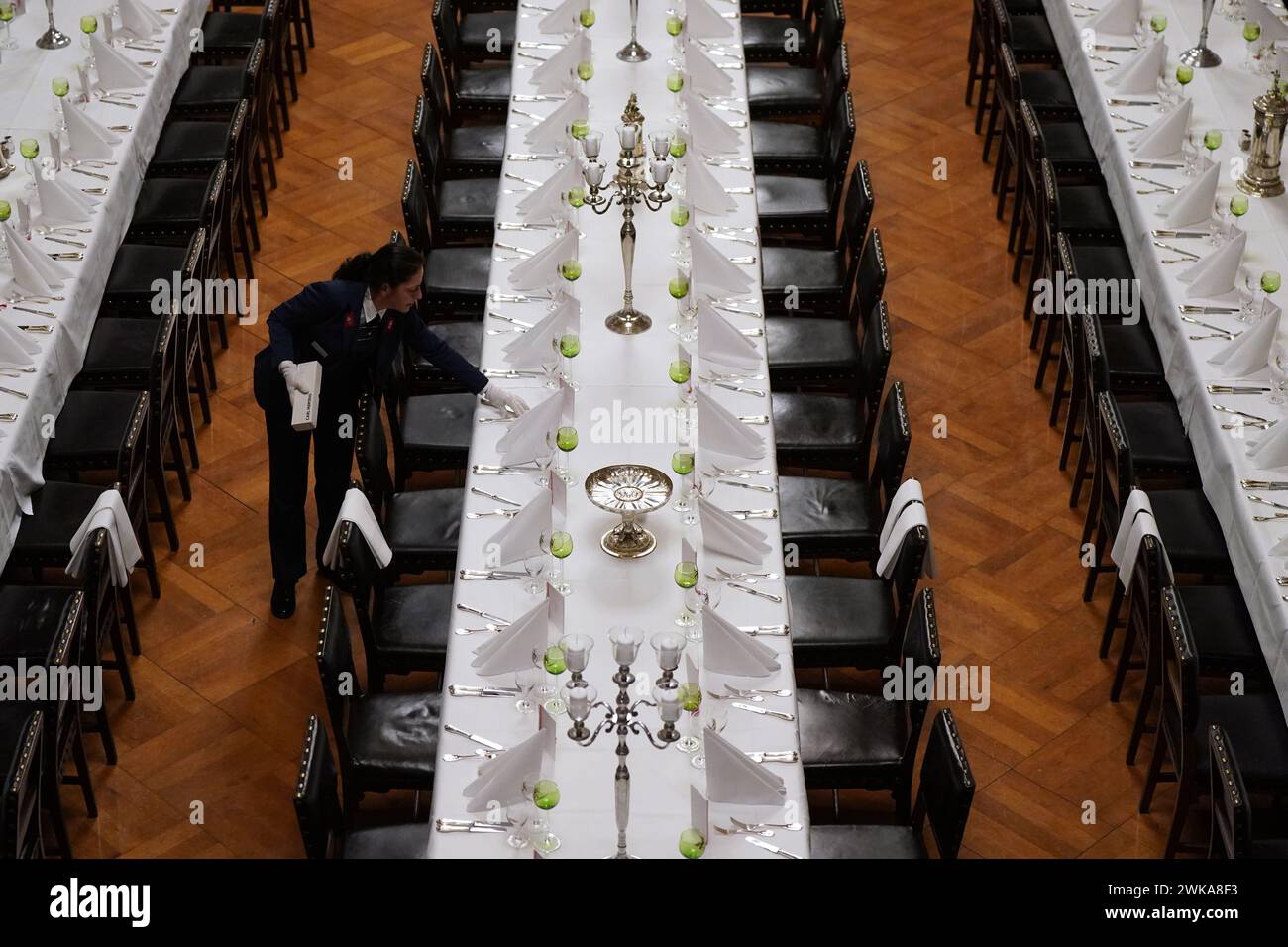 Hamburg, Germany. 19th Feb, 2024. Council servant Nadine Petermann checks the cutlery at the tables in the large banqueting hall during the final preparations for the traditional Matthiae meal of the Hamburg Senate in City Hall. The Prime Minister of the Republic of Estonia, Kallas, and Federal Chancellor Scholz are expected to attend the Matthiae meal as guests of honor. The Matthiae banquet is considered to be the oldest still celebrated banquet in the world. Credit: Marcus Brandt/dpa/Alamy Live News Stock Photo