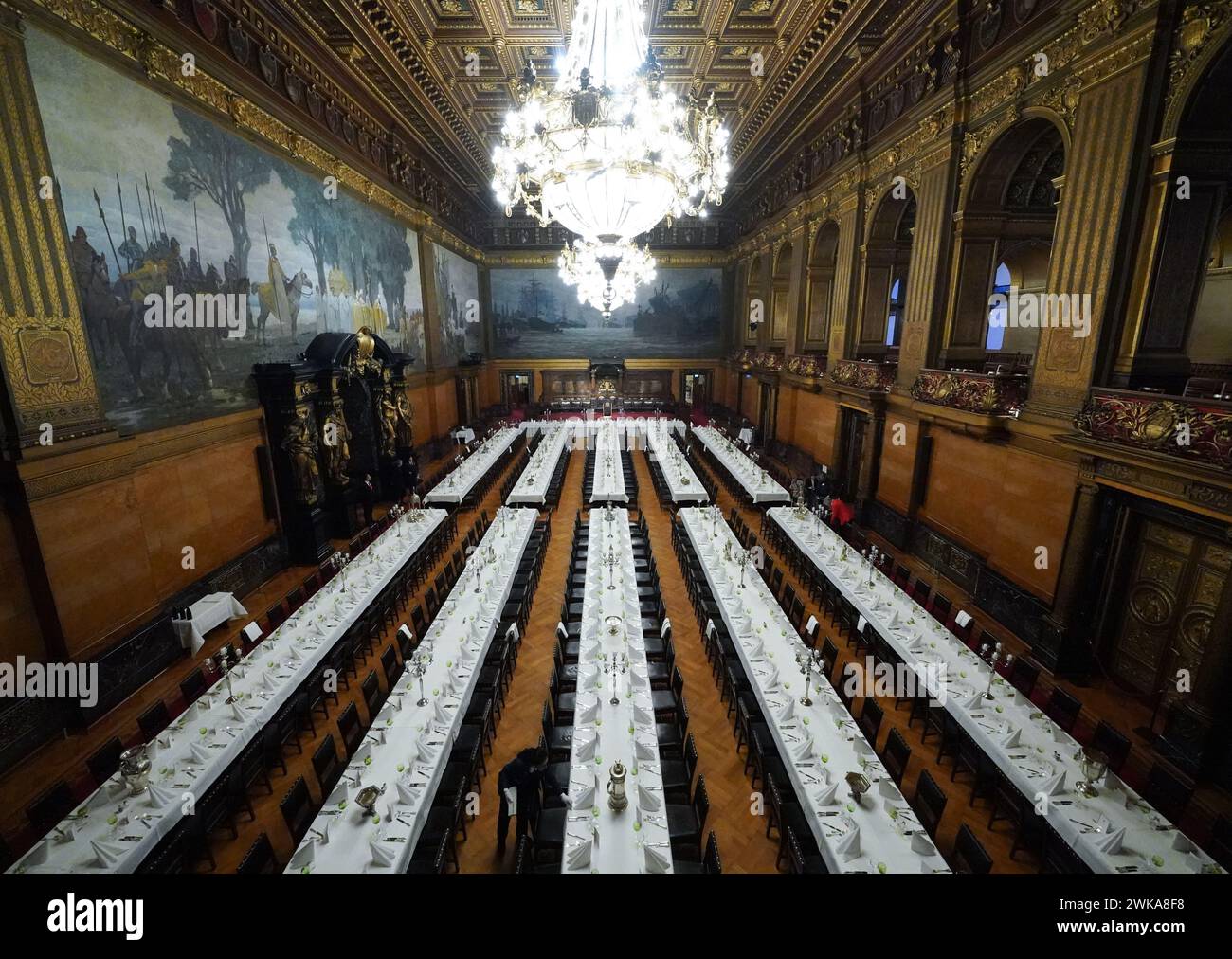 Hamburg, Germany. 19th Feb, 2024. Council servant Nadine Petermann checks the cutlery at the tables in the large banqueting hall during the final preparations for the traditional Matthiae meal of the Hamburg Senate in City Hall. The Prime Minister of the Republic of Estonia, Kallas, and Federal Chancellor Scholz are expected to attend the Matthiae meal as guests of honor. The Matthiae banquet is considered to be the oldest still celebrated banquet in the world. Credit: Marcus Brandt/dpa/Alamy Live News Stock Photo