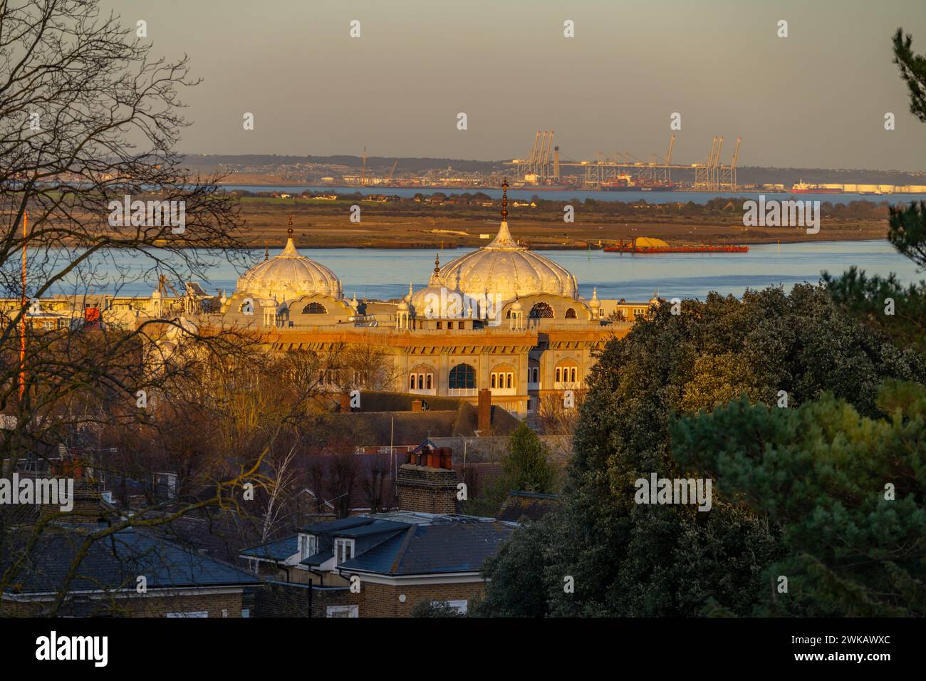Looking towards London Gateway Port at Coryton. With the domes of the Gravesend Gurdwara in the foreground. From Windmill hill at Sunset. Stock Photo